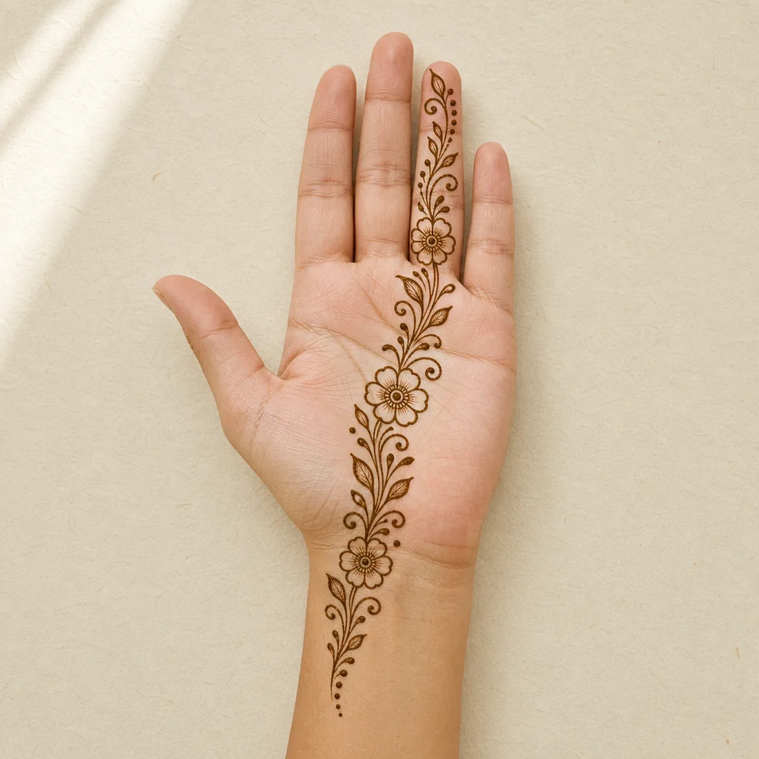 Hand placement preview of an easy front hand floral trail mehndi design